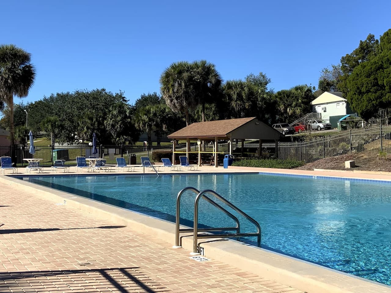 Recently resurfaced in December 2021, the HEATED Olympic-sized swimming pool is in pristine condition and has plenty of lounge chairs and a covered picnic/grill area.
