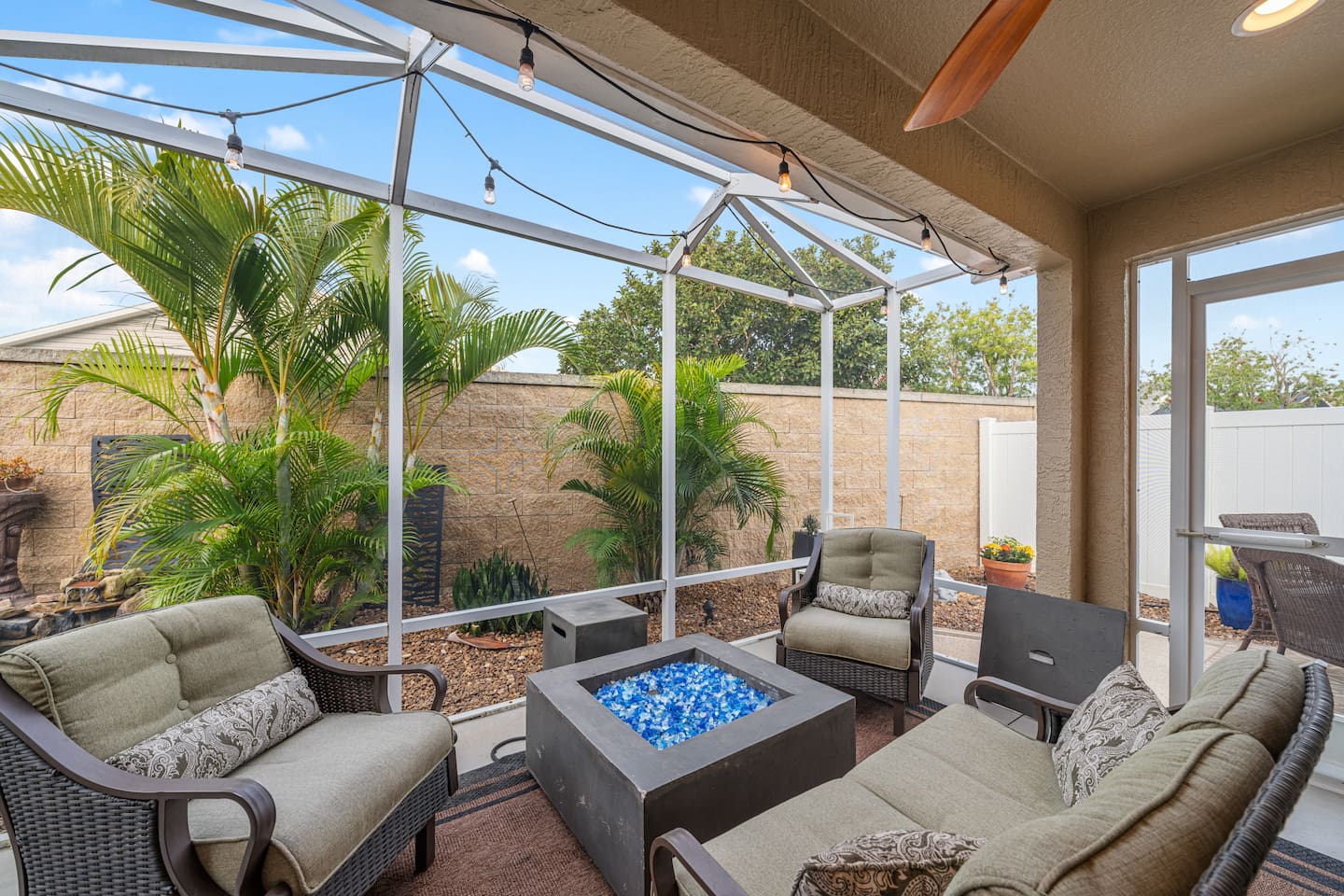 The screened lanai features a propane firepit, string lighting and a waterfall feature to ensure a peaceful and serene stay!