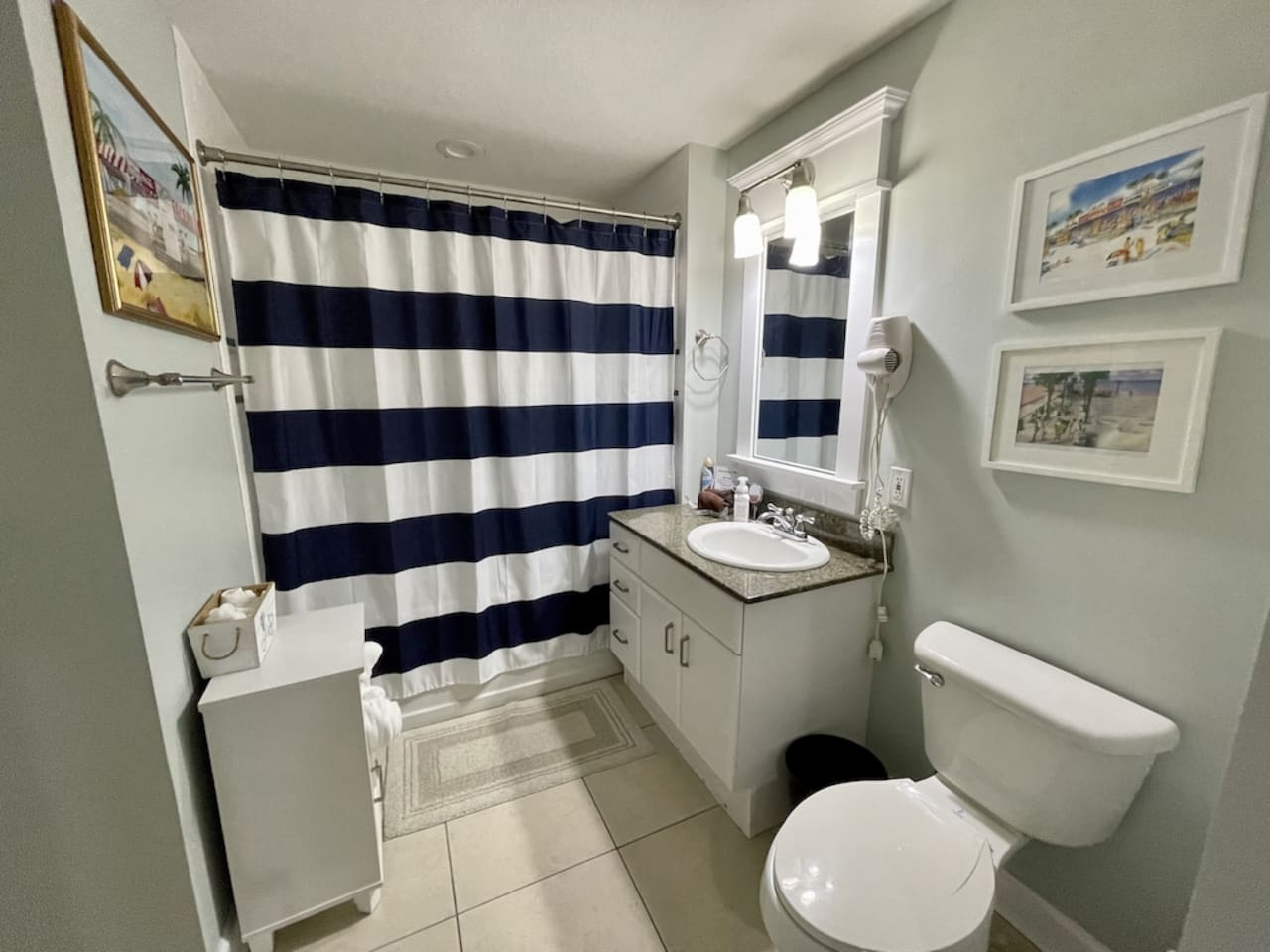 Bathroom with tub and shower, opens to hallway and second bedroom