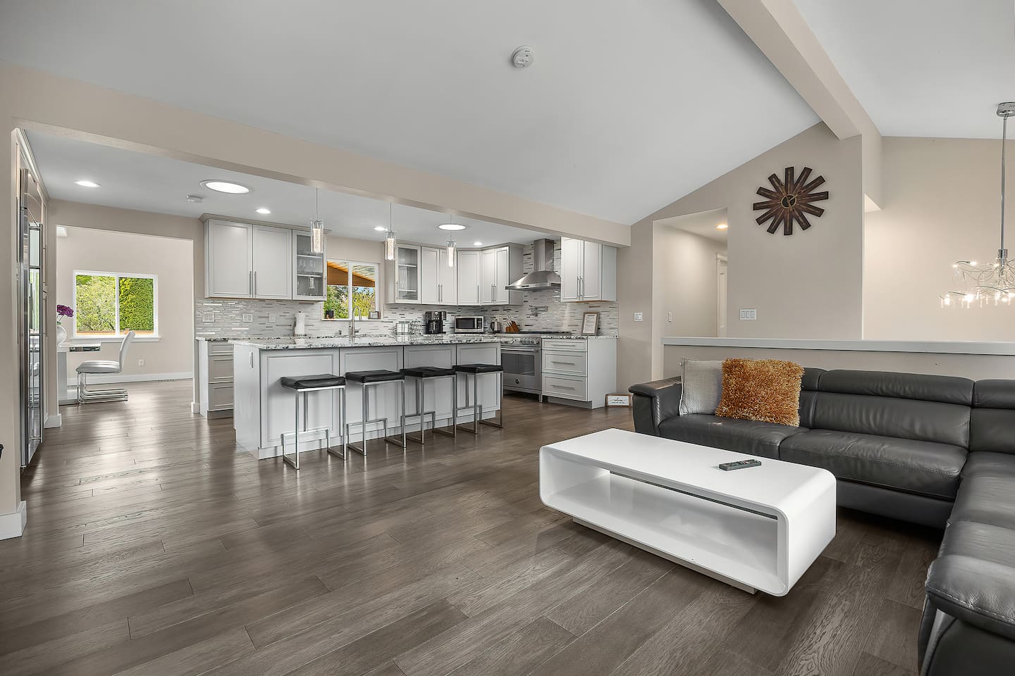 “This open-concept kitchen and living room creates a seamless flow, featuring high-end finishes, abundant natural light, and stylish furnishings—perfect for relaxing or entertaining.”