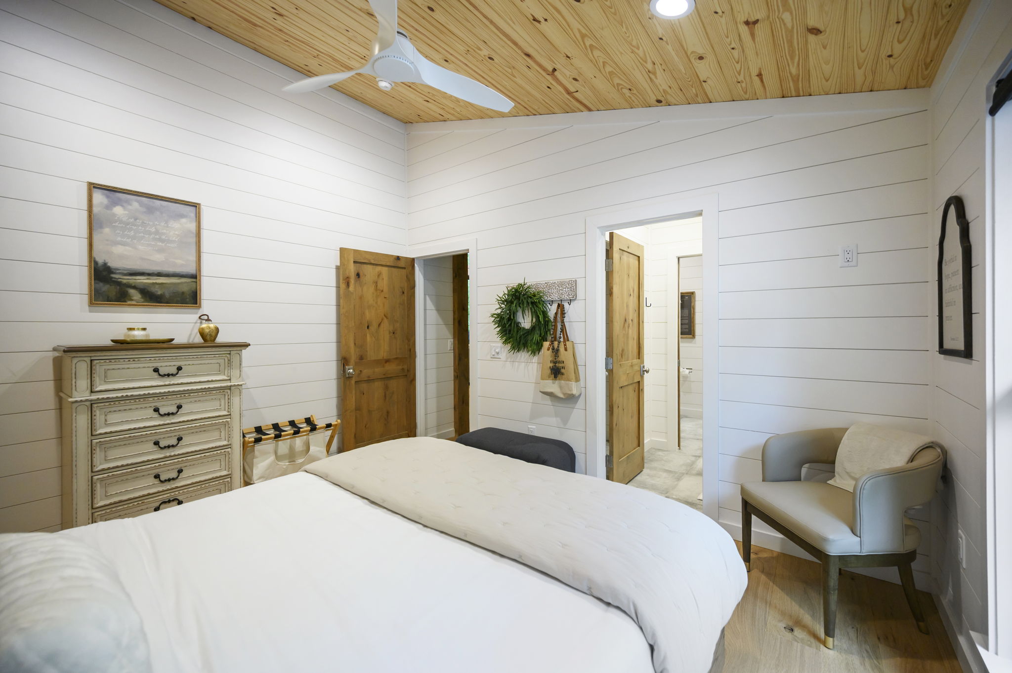 A beautifully appointed queen bedroom featuring luxury design, high-end linens, and peaceful forest views.