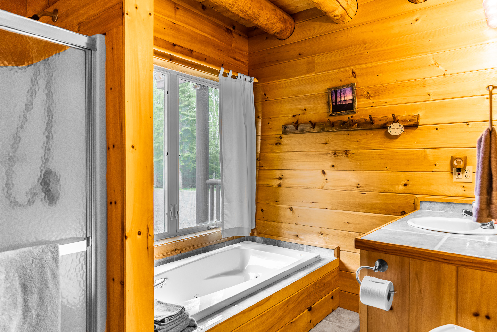 The private bathroom off of the main floor master ensuite, with a soaking jet tub plus a separate shower.