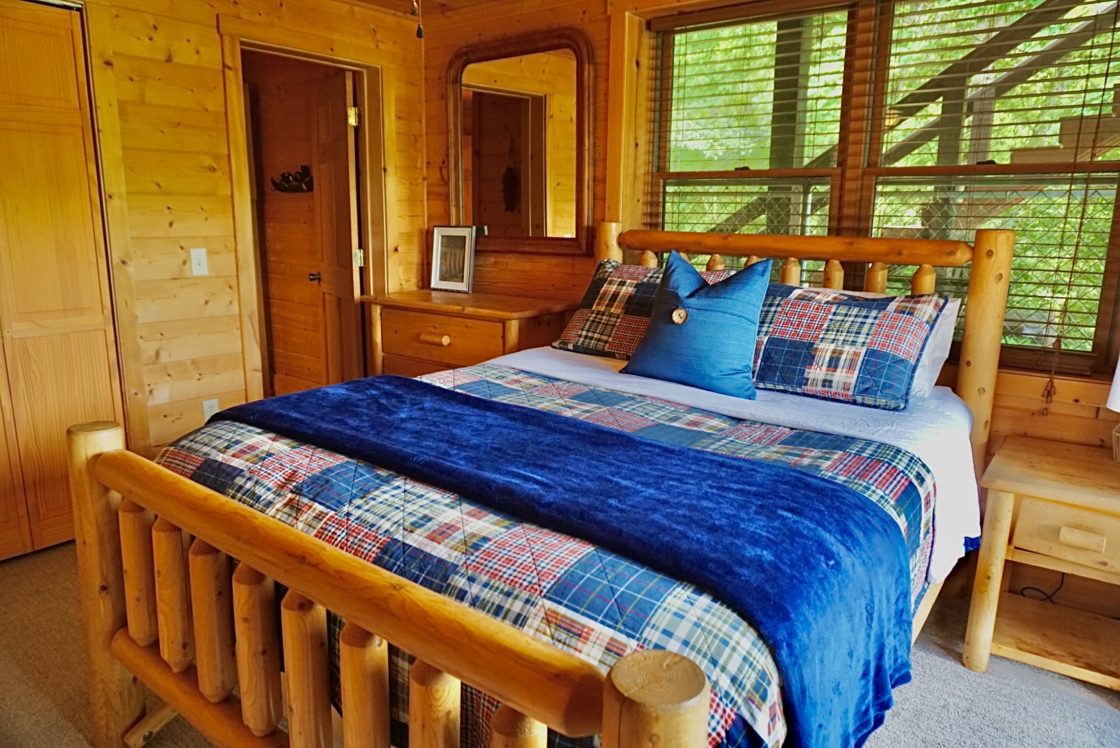 Enjoy nature views from this charming cabin room, featuring rustic decor and warm tones!