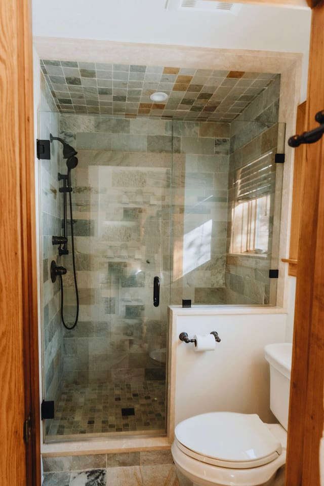 The shower and toilet are in a separate room within the larger bathroom for added privacy
