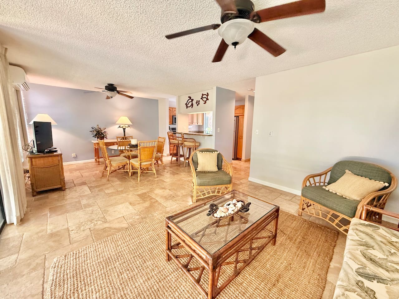 Roomy living room with sleeper sofa (queen) couch, 2 chairs, television and opens to the lanai.