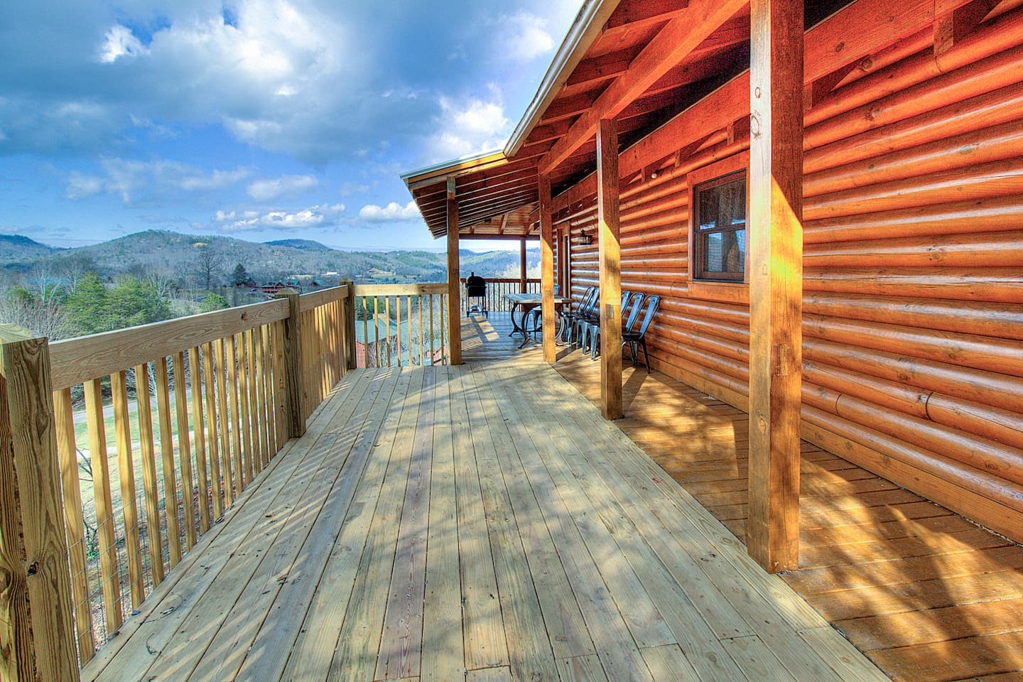 Back deck with table/chairs grill on one side and hot tub on the other side