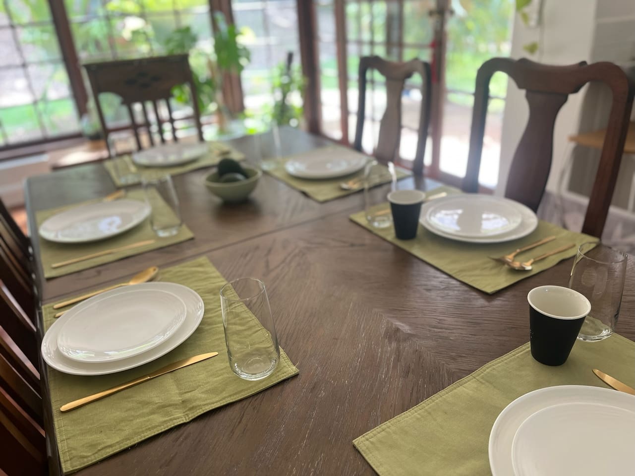 Relaxed family dining table, next to kitchen,  with views and access to yard and verandas. Beautiful timber screened door lets the breezes in…