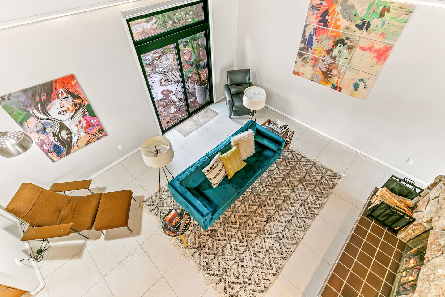 Welcome to the enchanting Living Room, furnished with a velvet sofa for intimate conversations, a two-sided fireplace, and easy access to the outdoor area, kitchen, and patio.