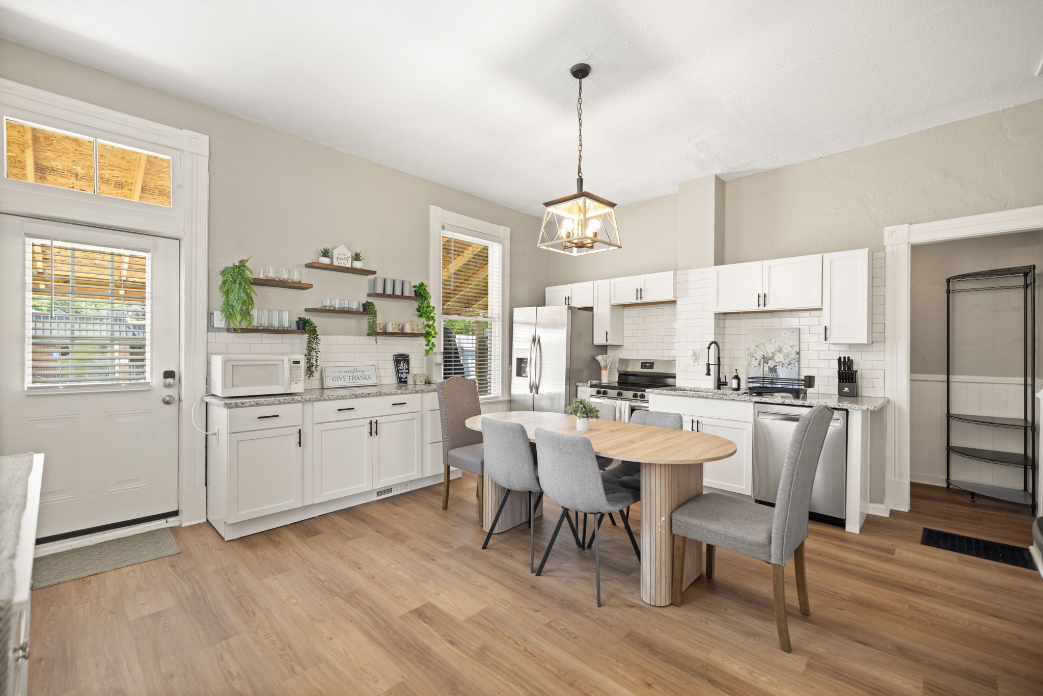 Spacious kitchen with center island, designer pendant lighting, and generous prep and storage space