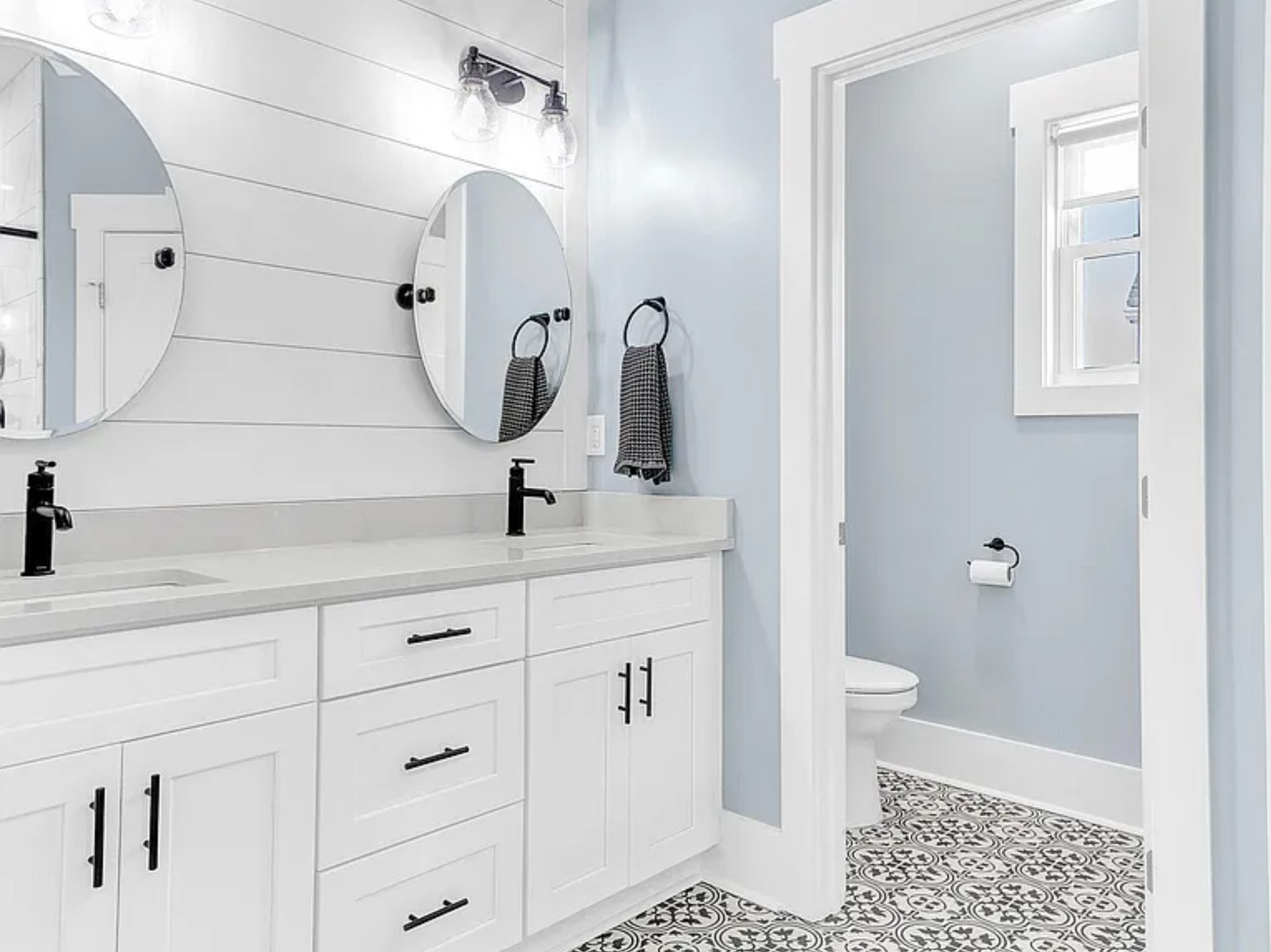 Bright primary bathroom with double vanity and modern finishes.
