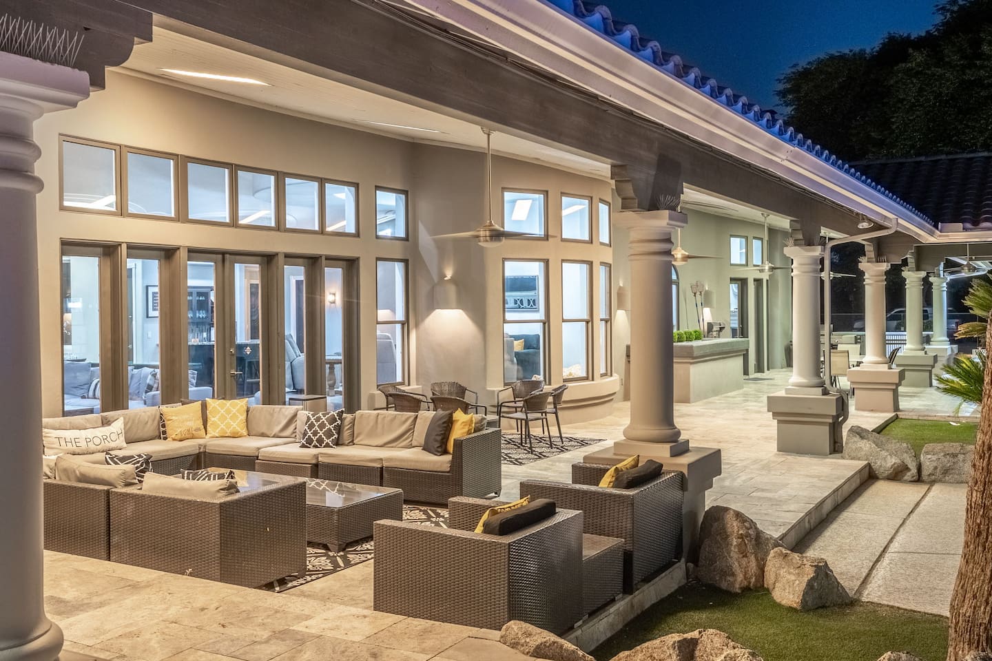 Featuring stately columns and sophisticated lighting, this covered patio blends style and comfort effortlessly.