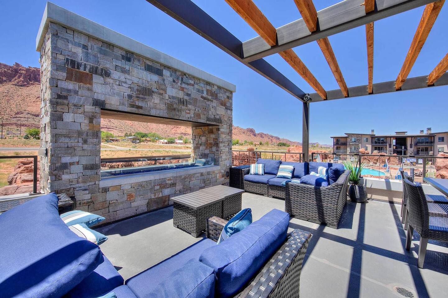 Poolside lounge overlooking the pool with fireplace and BBQ