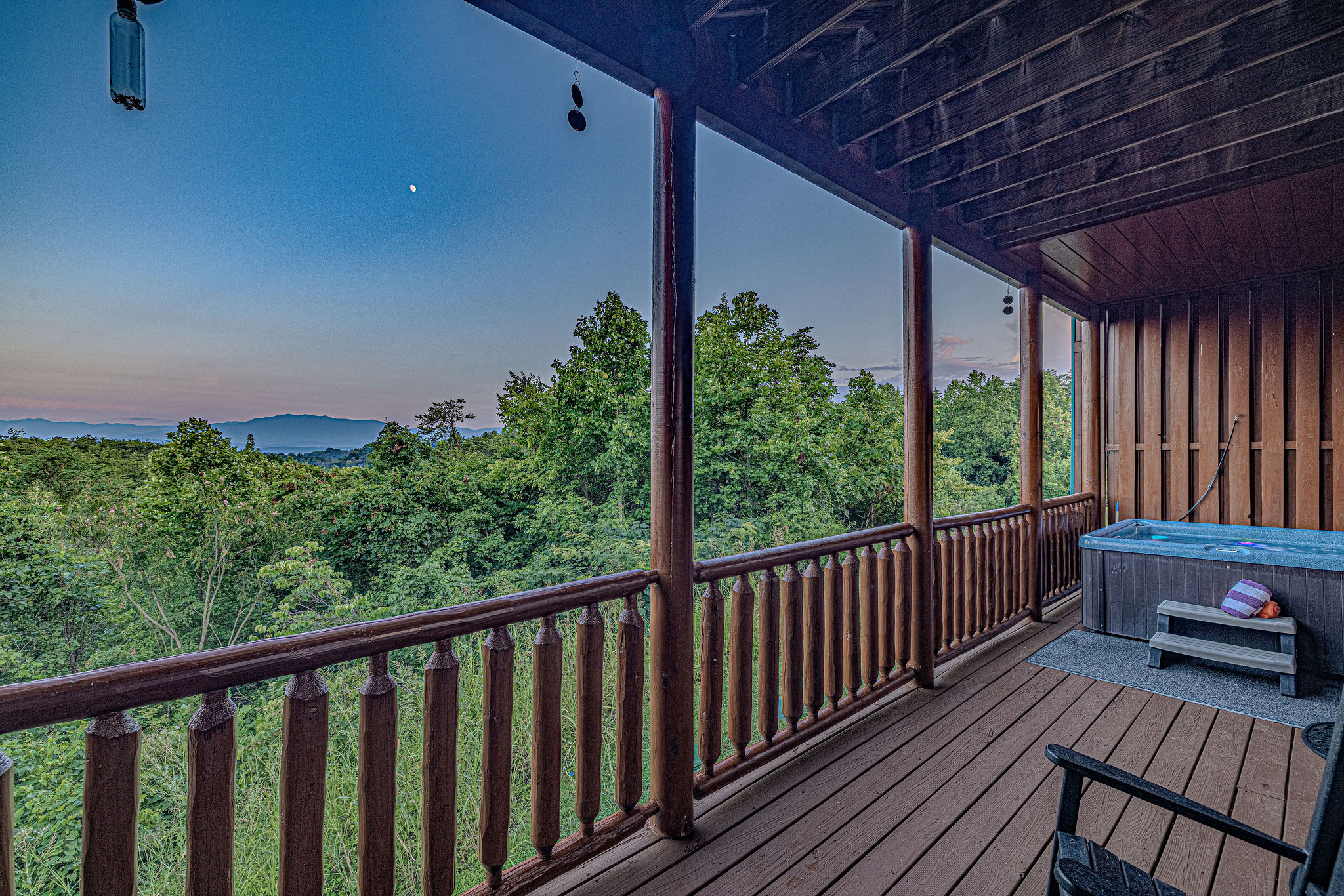Lower deck retreat: calming forest views and a hot tub for easy relaxation..