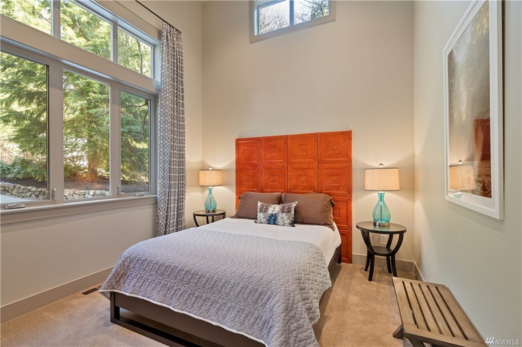 Queen bedroom on the lower level with peaceful views of the surrounding nature.