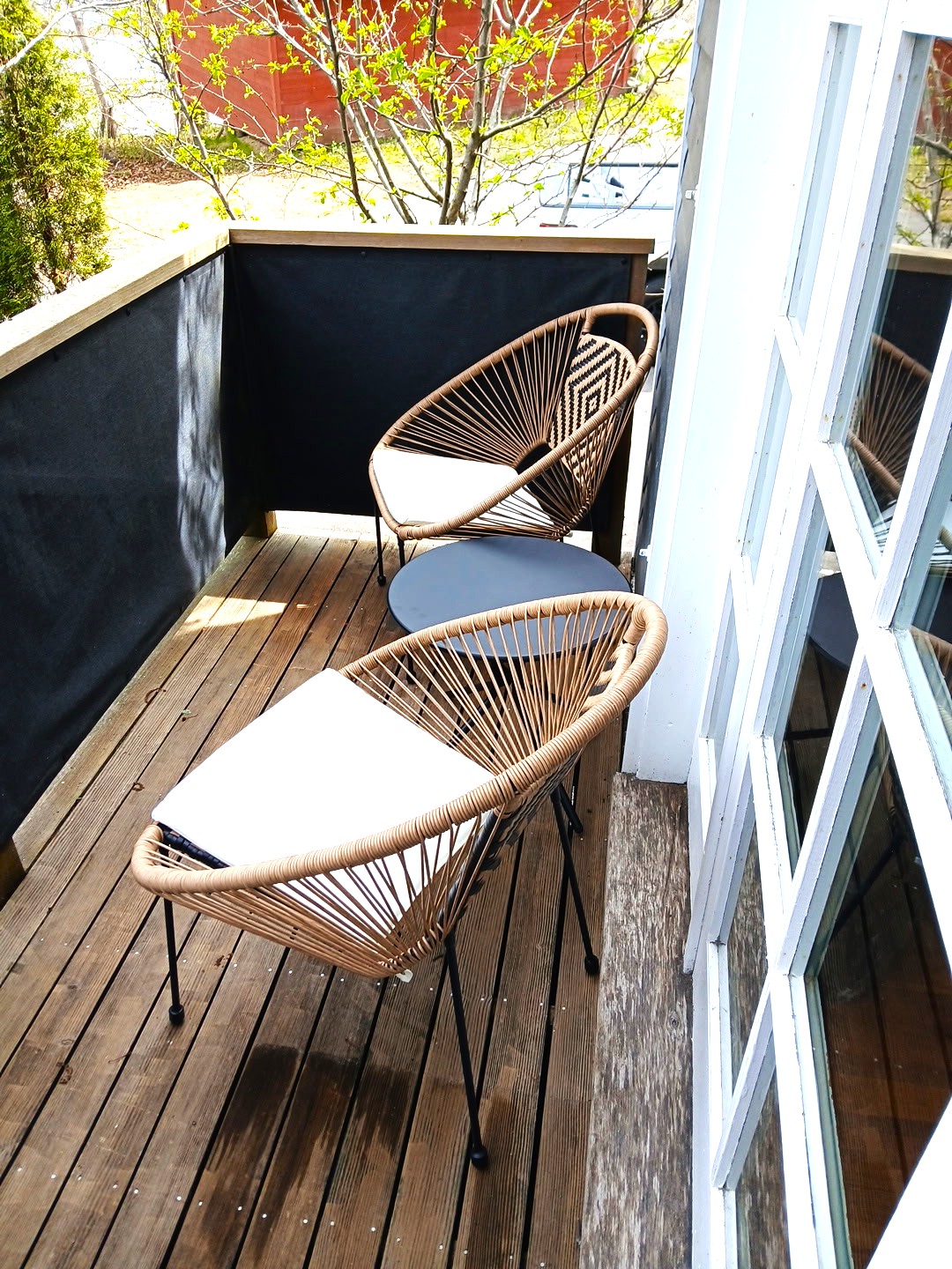 The Captain's private morning retreat. Step through the primary French doors to find your own bistro balcony—the only spot on the property to catch a glimpse of the ocean. This quiet perch overlooks the cedar-lined patio, offering the perfect hidden nook f