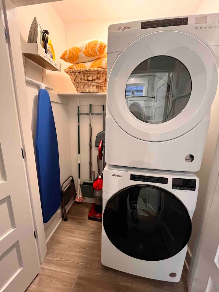 Laundry and cleaning supplies in hallway closet.