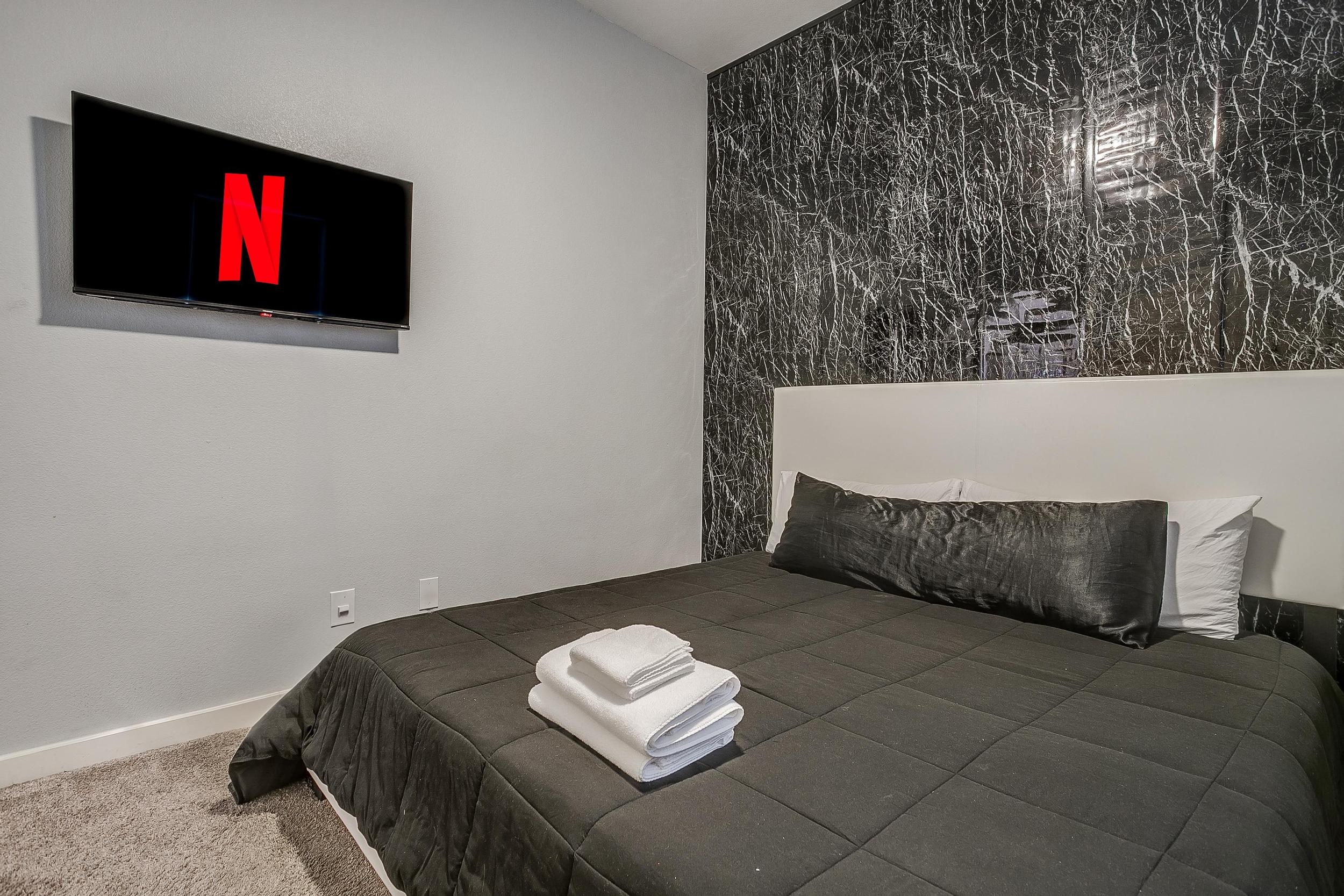 Comfortable bedroom with Smart TV + Netflix ready for movie nights.