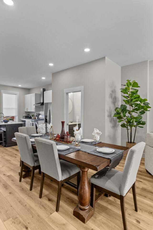 Large dining table with seating for 6-7 (4 chairs and one long bench).
