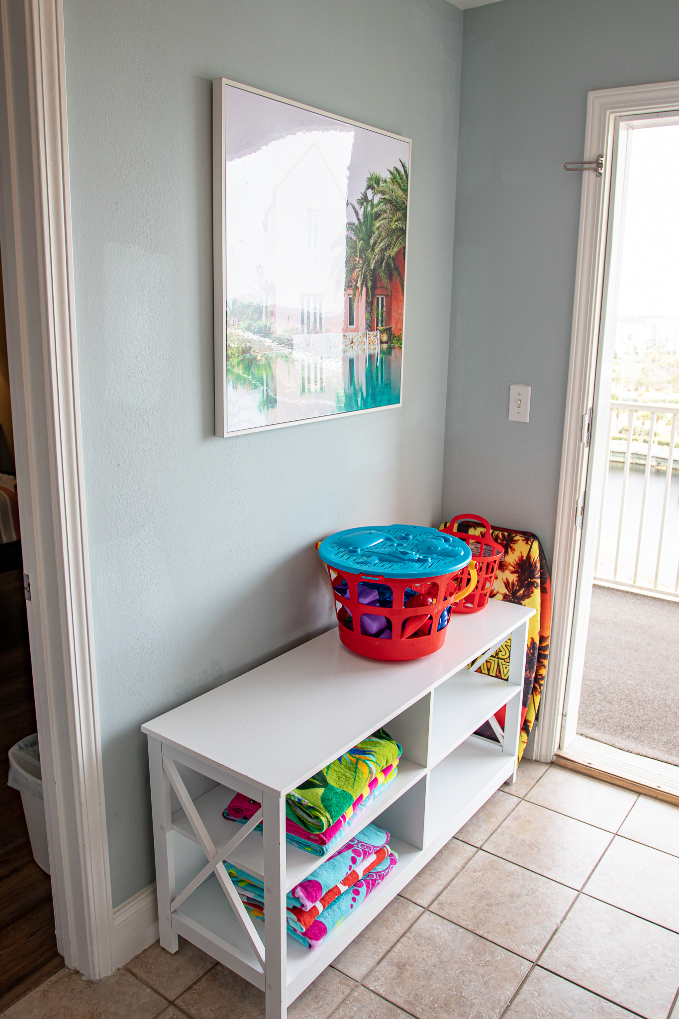 cubby with pool toys and beach towels to use durin