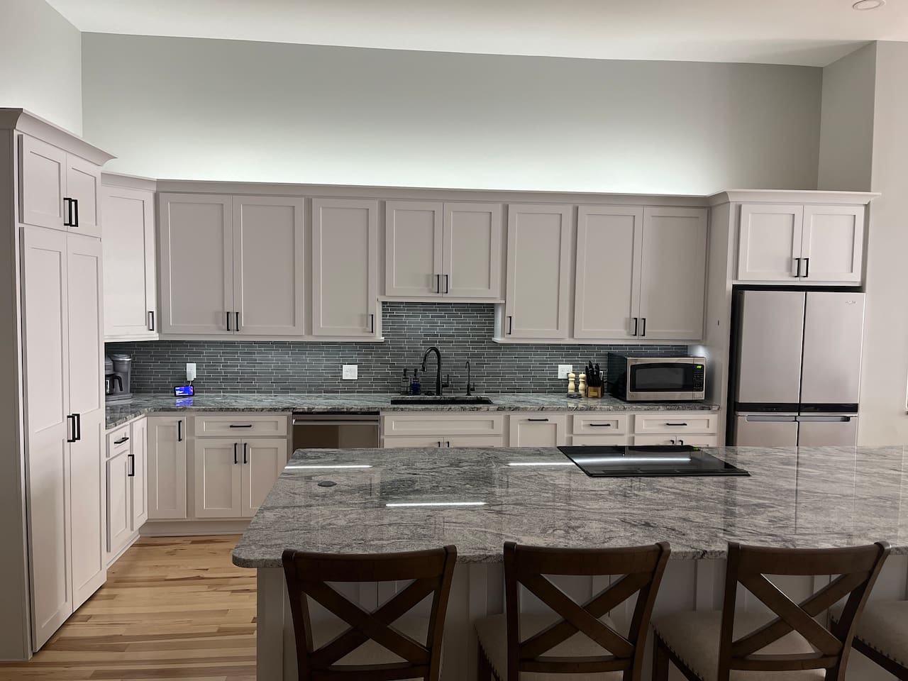 You will notice a small silver bar on the cabinet just left of the fridge. If you tap that bar it will turn on our under/over cabinet lights!  If you press and hold it the lights will dim.  If you press and hold it a second time they will brighten! 