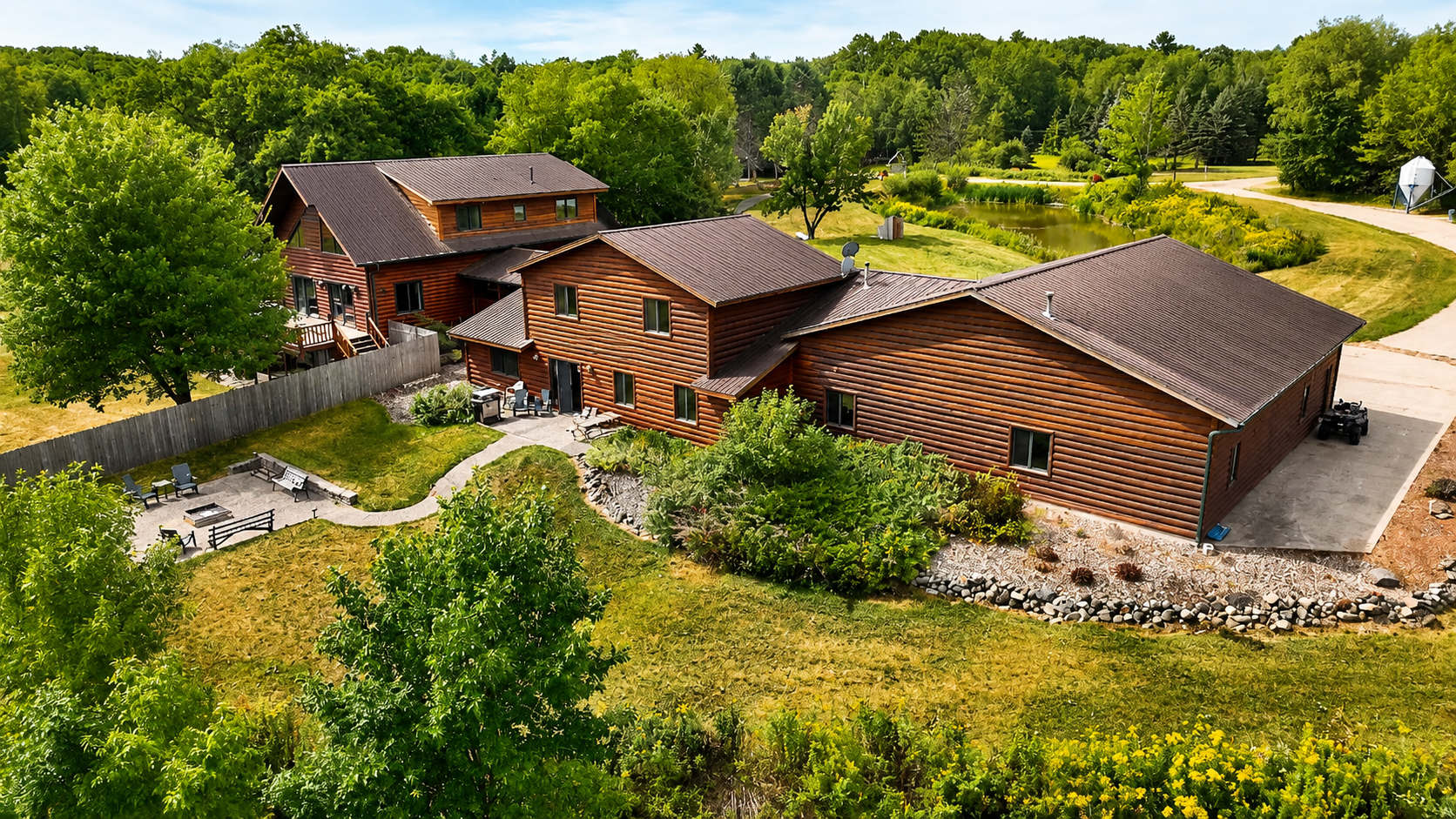 Beautiful aerial view of the lodge and surrounding Northwoods property, highlighting the spacious grounds, easy access, outdoor gathering areas, and room for your group to enjoy a true Wisconsin getaway.