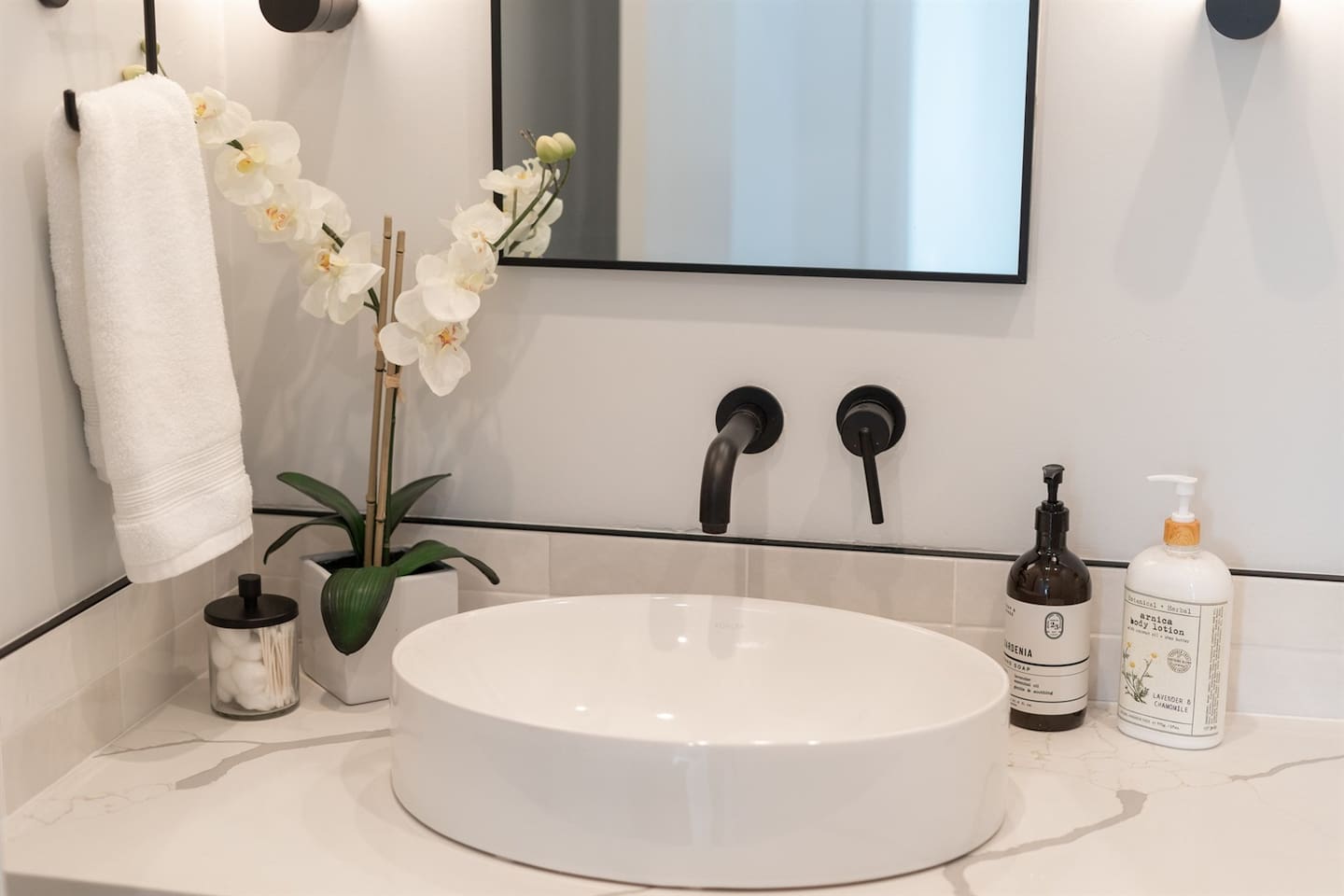 The half bathroom features a clean design with a practical vanity and toilet, making it a great addition for any home.