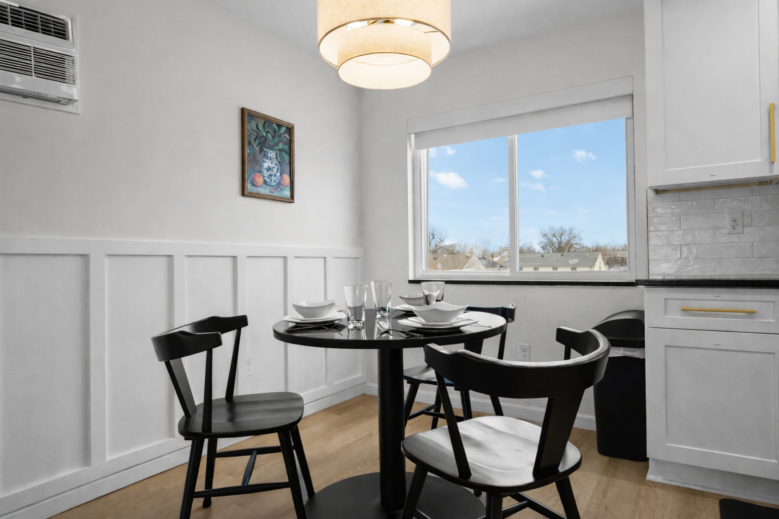 Bright dining space with modern table, cozy seating, and warm lighting—perfect for enjoying meals, morning coffee, or relaxed evenings in.
