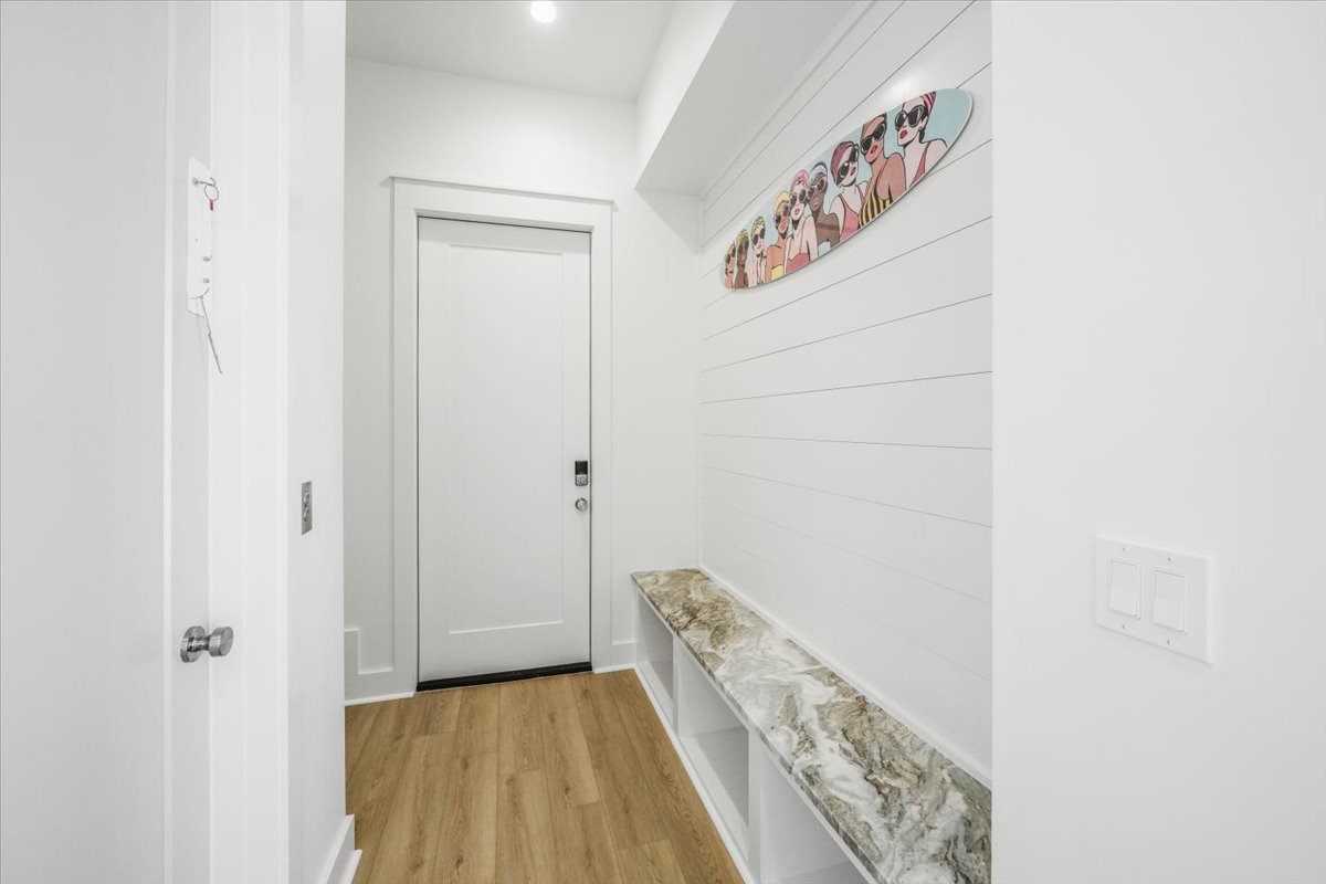Ground level offers direct access to the garage and under the house where you can access the beach, outdoor shower, and pool via the gate.  There is also a convenient sand bench (no mud here!) with hooks above.