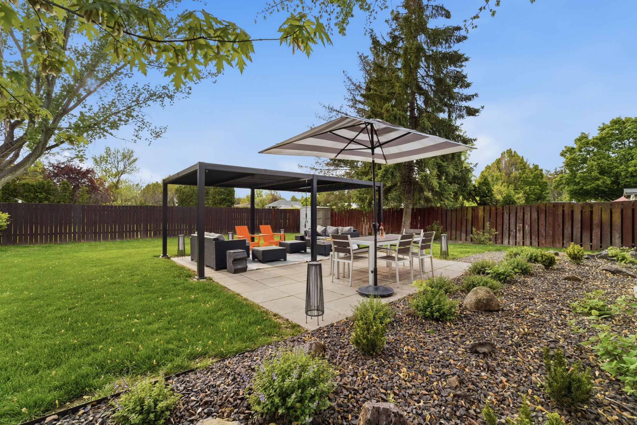 Patio area w/ dining table. covered lounge area.
