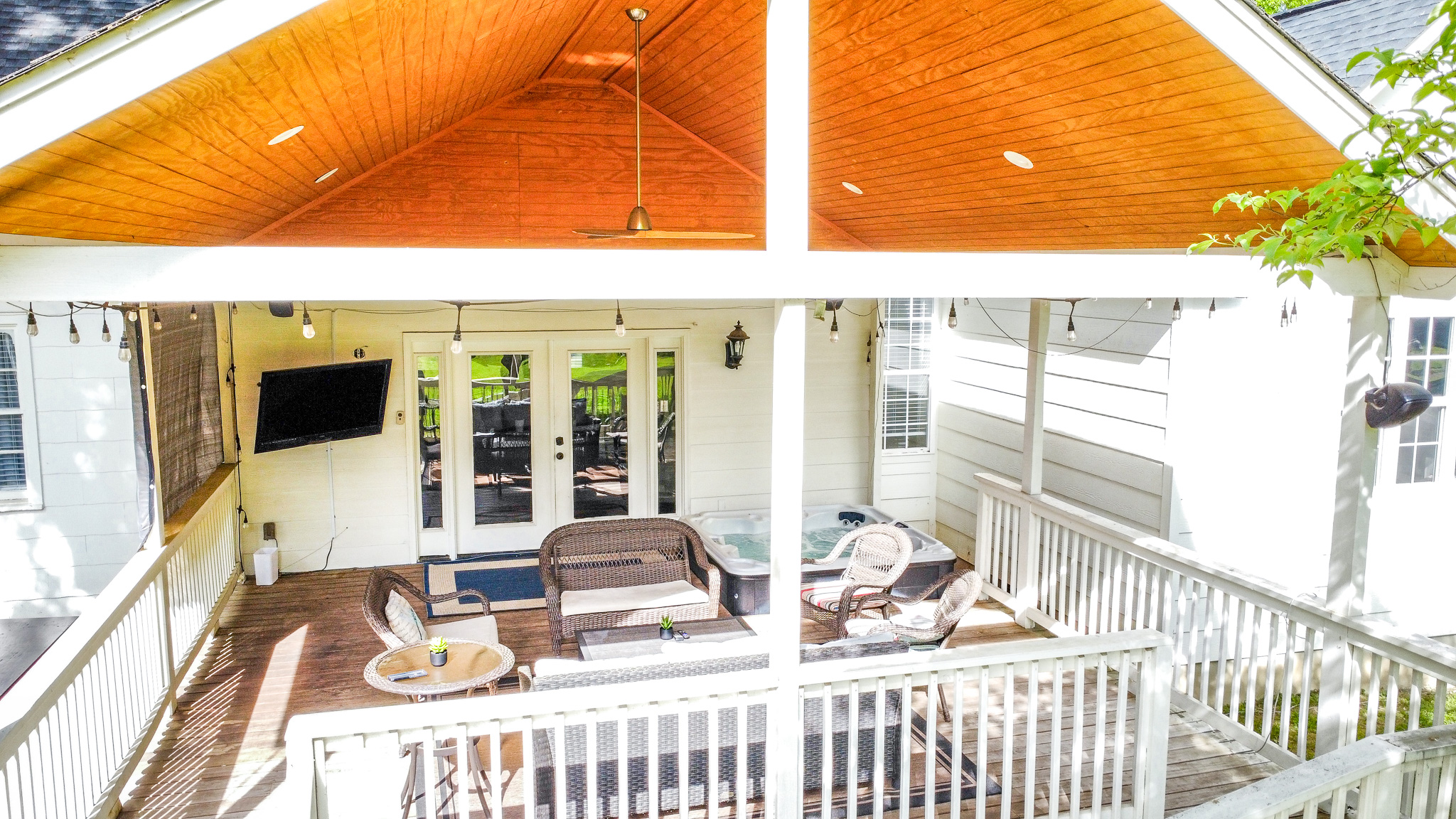 Covered deck with hot tub and TV