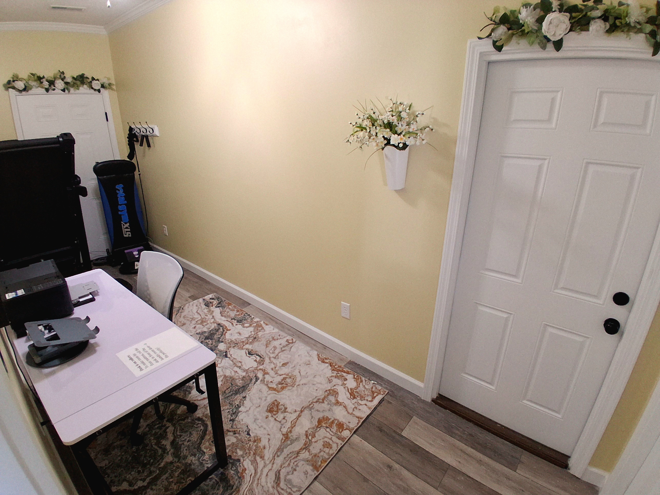 This private, lockable office doubles as a sleeping room. The lightweight, wheeled desk easily rolls in front of the laundry room door to clear space for a full-size floor mattress on the rug. Linens, pillows, and a mattress cover are provided.