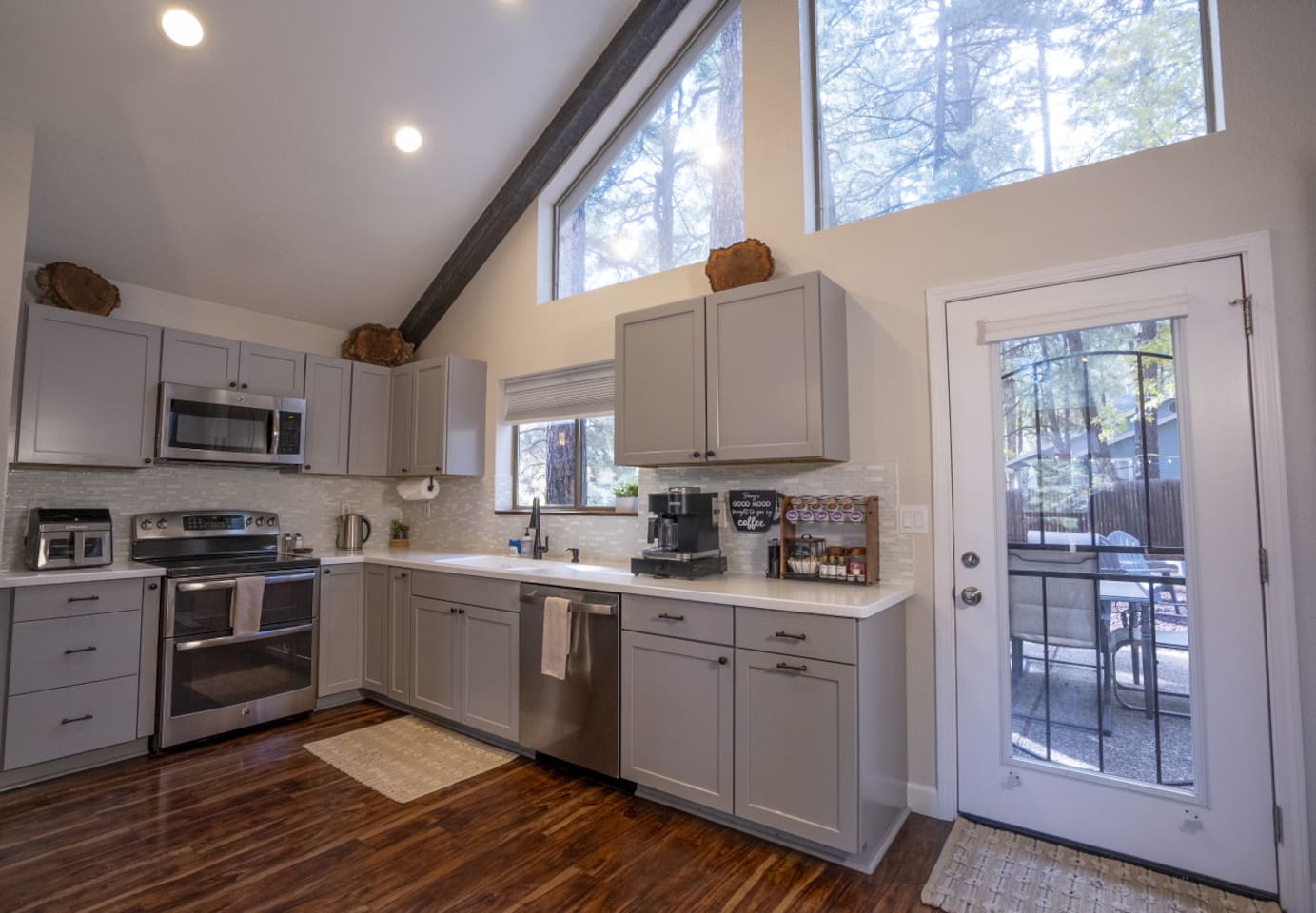 Bright kitchen with high ceilings, full-size appliances, and space for simple meals during your stay.