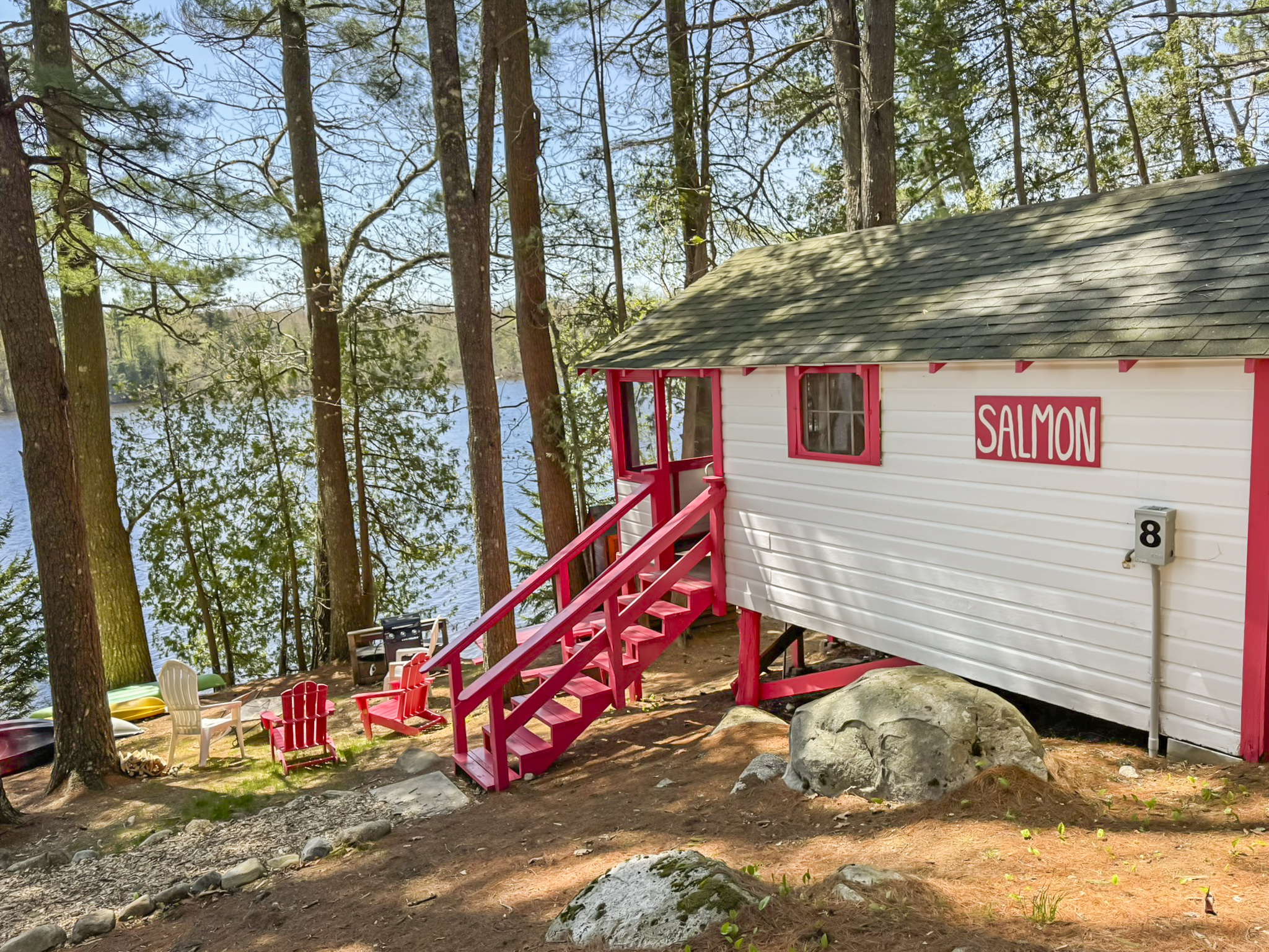 back view of the cabin, staring the stairs and the lake.