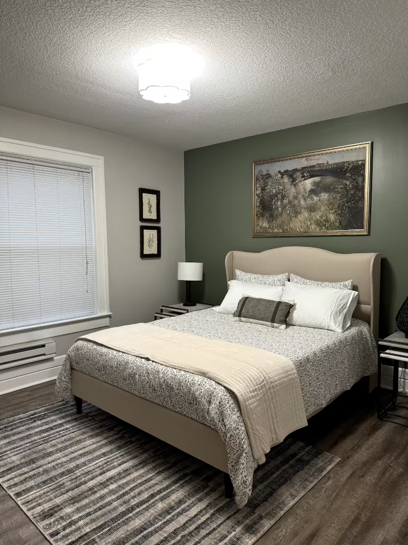 Sink into a plush queen bed layered with soft linens, ready for a night of deep, easy rest.