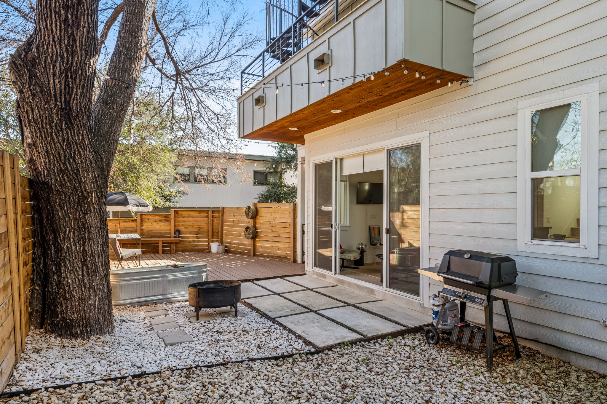 Private patio with outdoor seating and BBQ grill—perfect for relaxing or dining outside