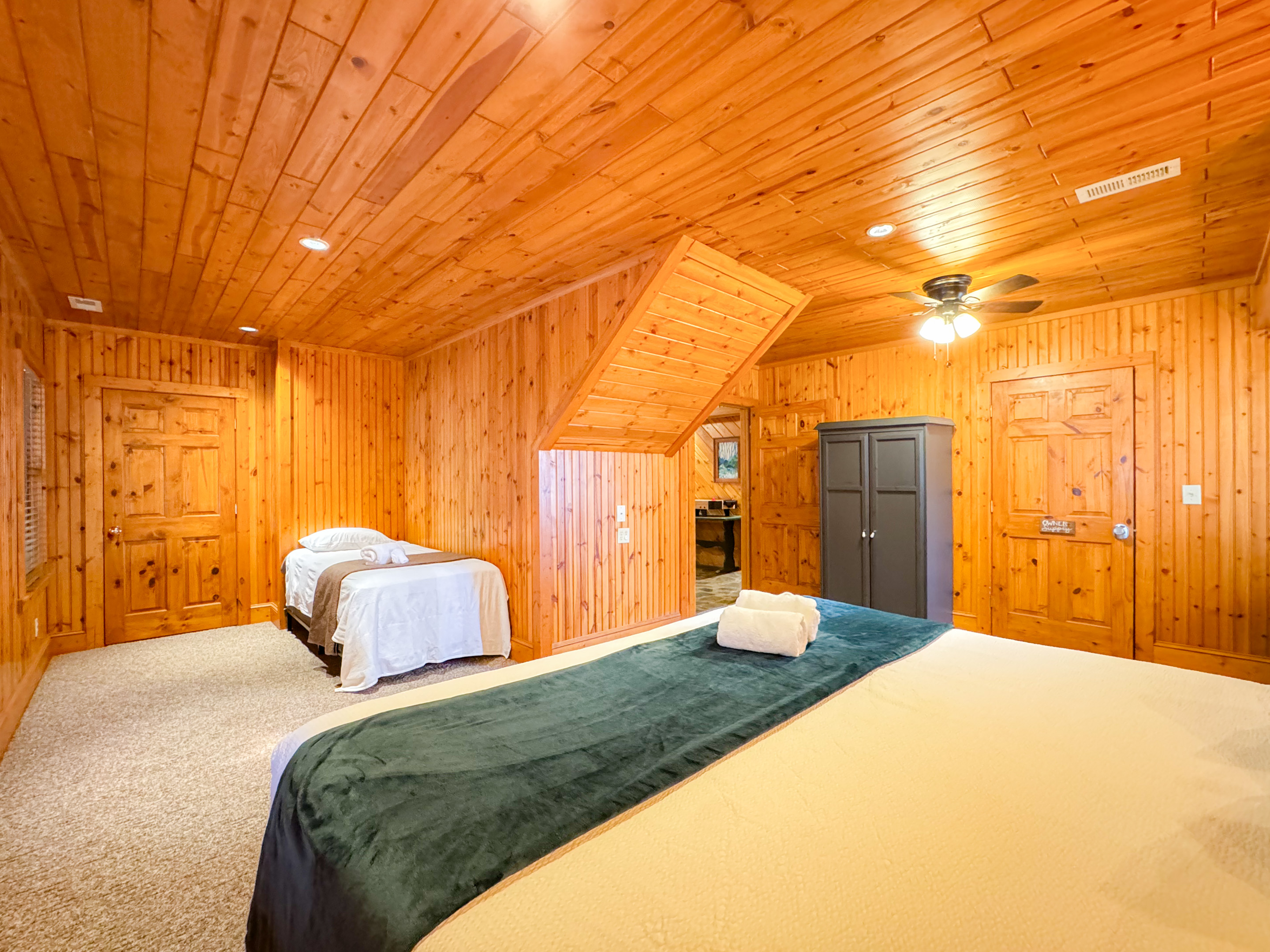 large lower level bedroom with a King Size bed and twin bed