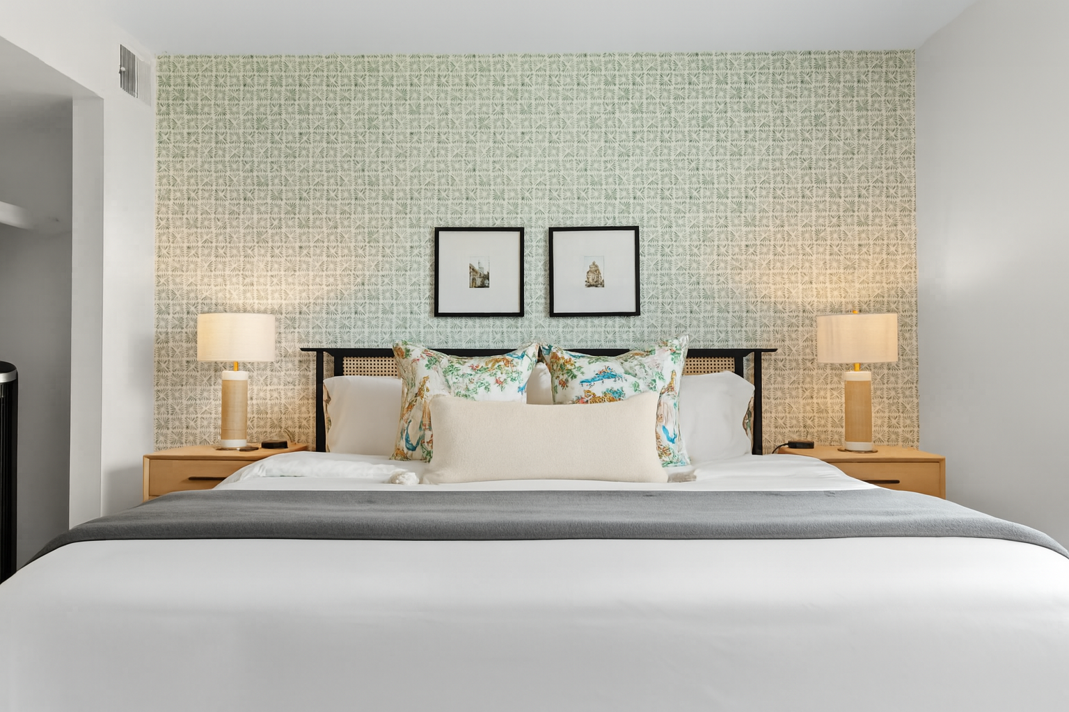 Bright and tranquil bedroom with accent wallpaper and a plush bed for a peaceful retreat.