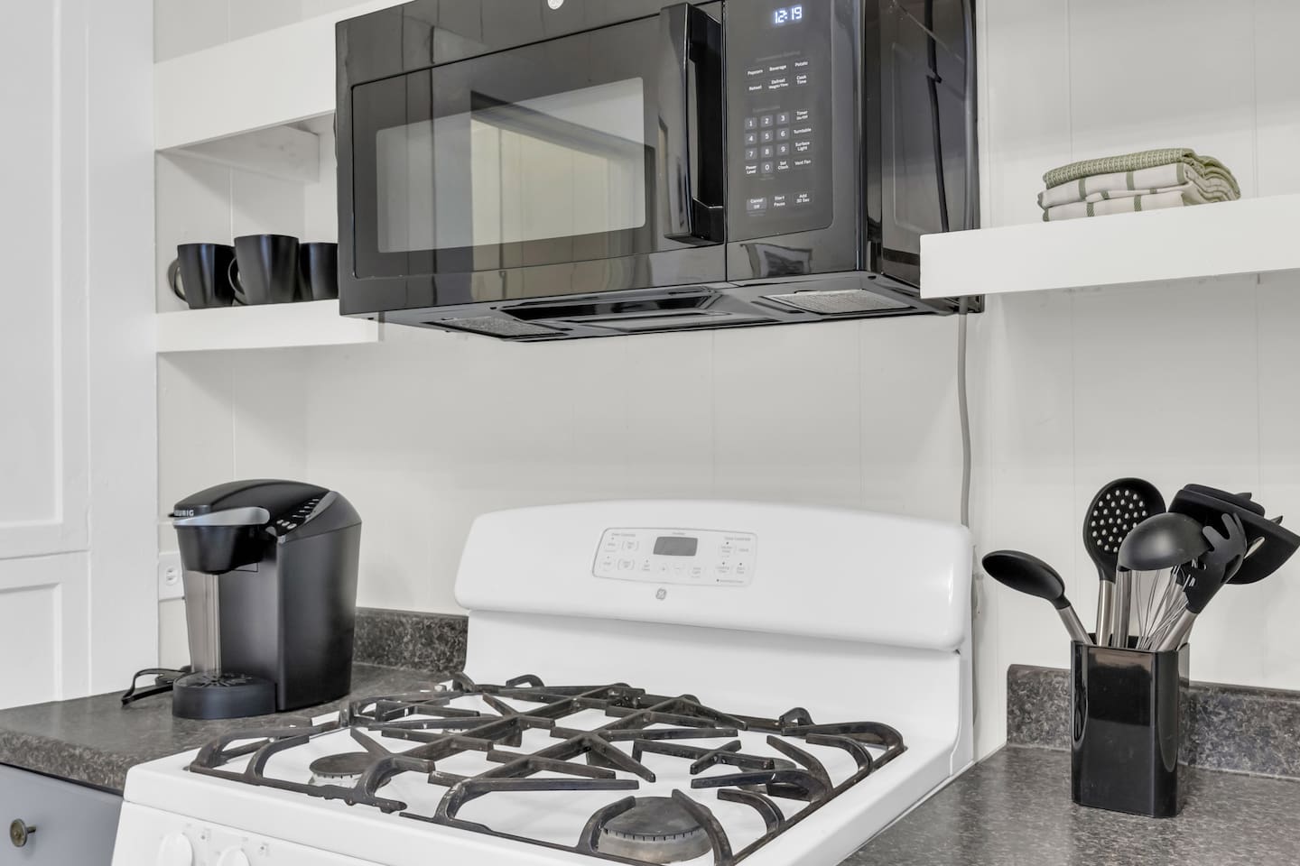 Kitchen with Keurig coffee maker, microwave,  gas range and modern appliances.