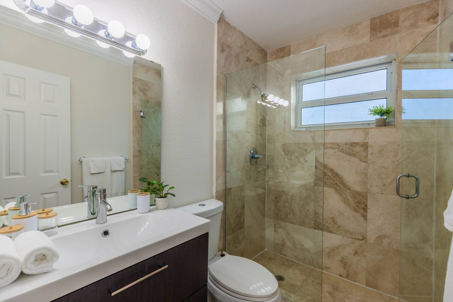 The Master en-suite Bathroom has been newly renovated bathroom with step in large shower and vanity. In the vanity you will find the hairdryer.