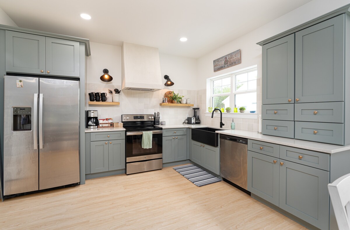 A proper kitchen, not a token one: a full-size range and oven, a dishwasher, a side-by-side refrigerator with ice in the door, and enough counter space to genuinely spread out when you are feeding a houseful.
