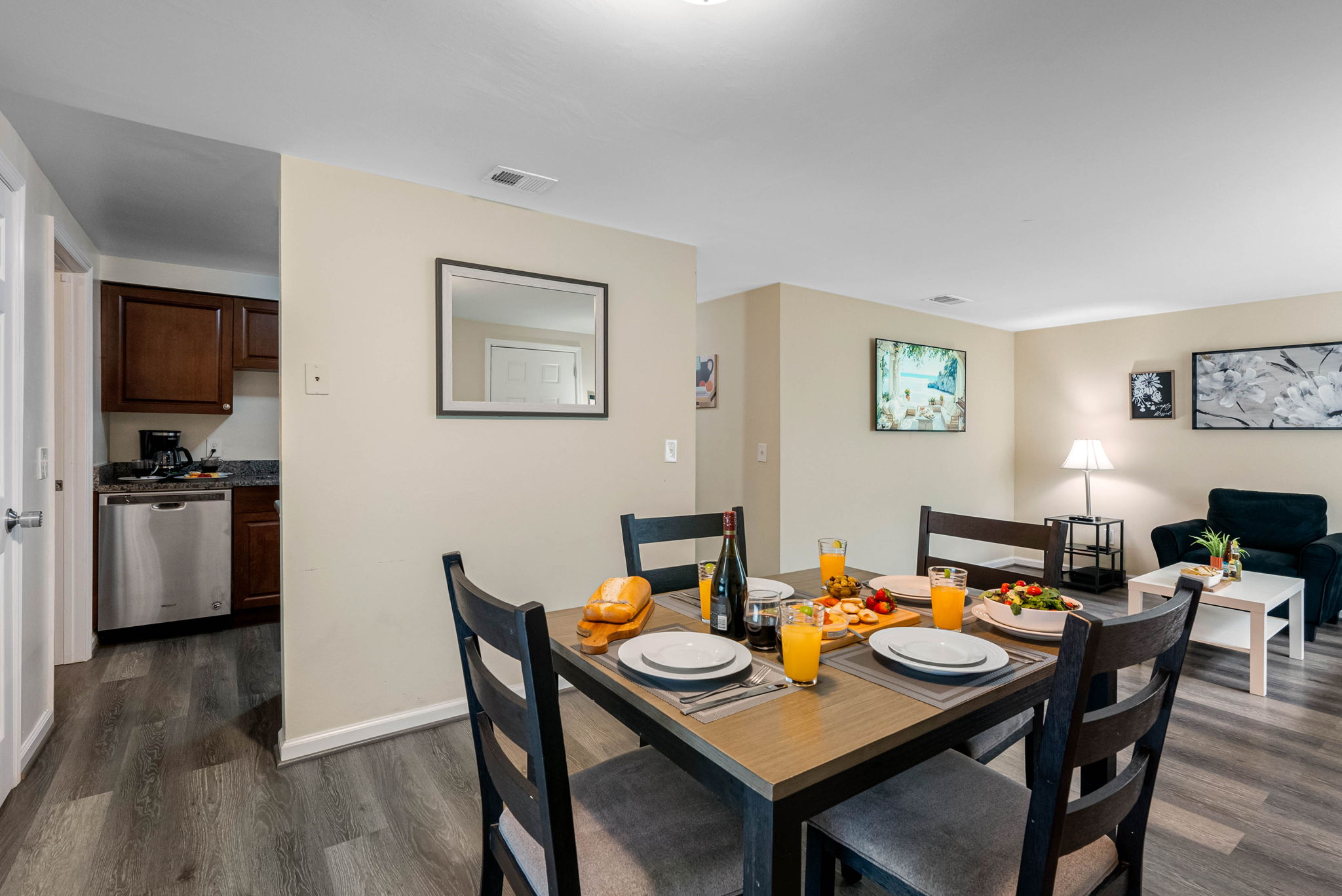 Framed by light neutral walls and rich wood-look flooring, the space exudes a calm, homey feel that seamlessly complements the adjoining living area.