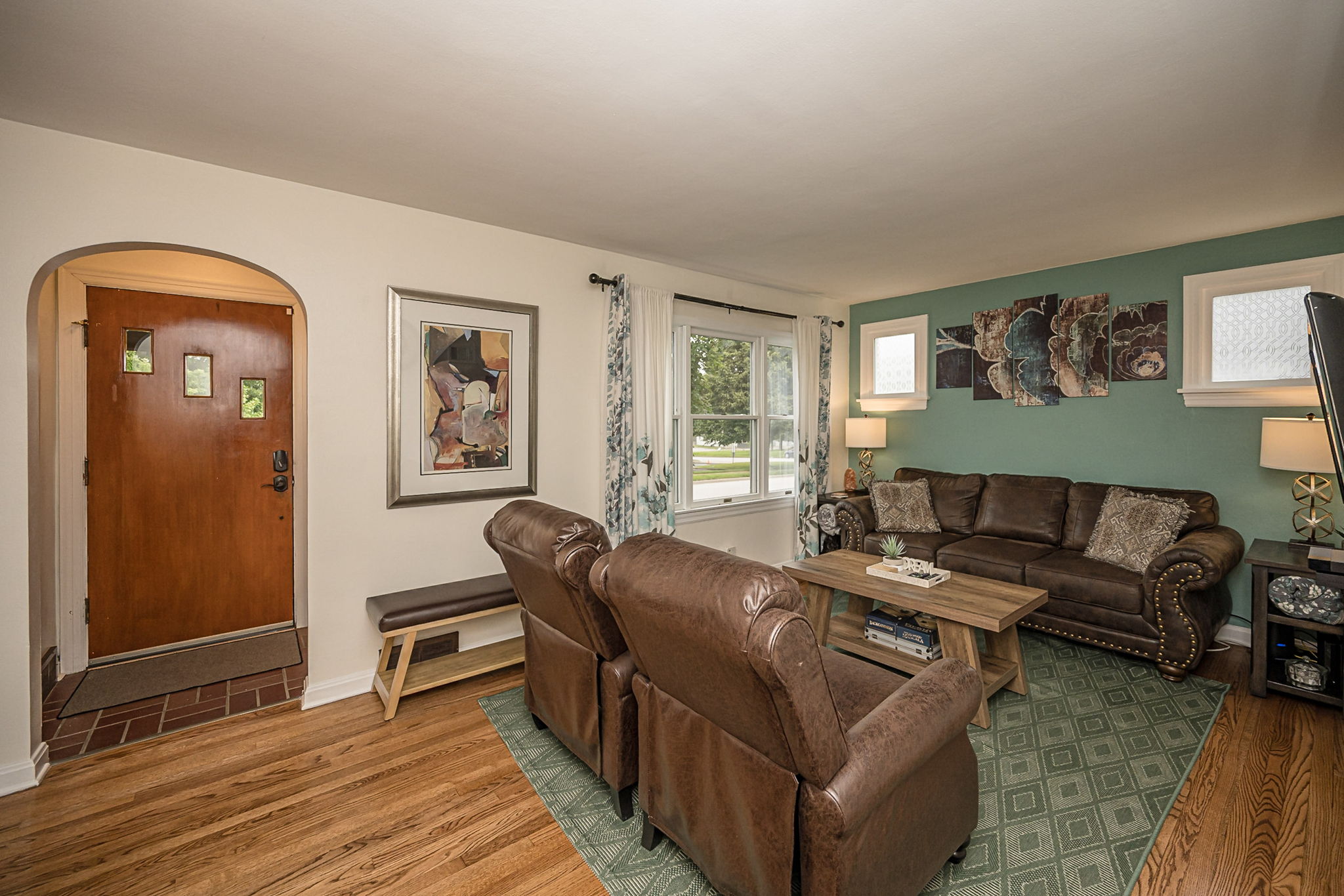Another view of the spacious living room and front entry.