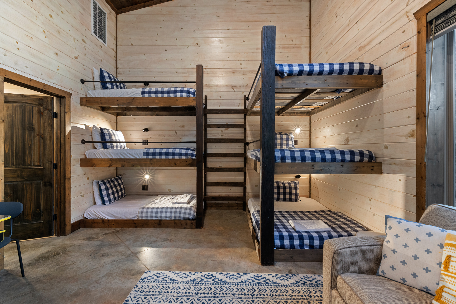 Play foosball, arcade, watch a movie, or just relax in this bright, forest view space made for fun and connection in the bunkhouse gameroom.
