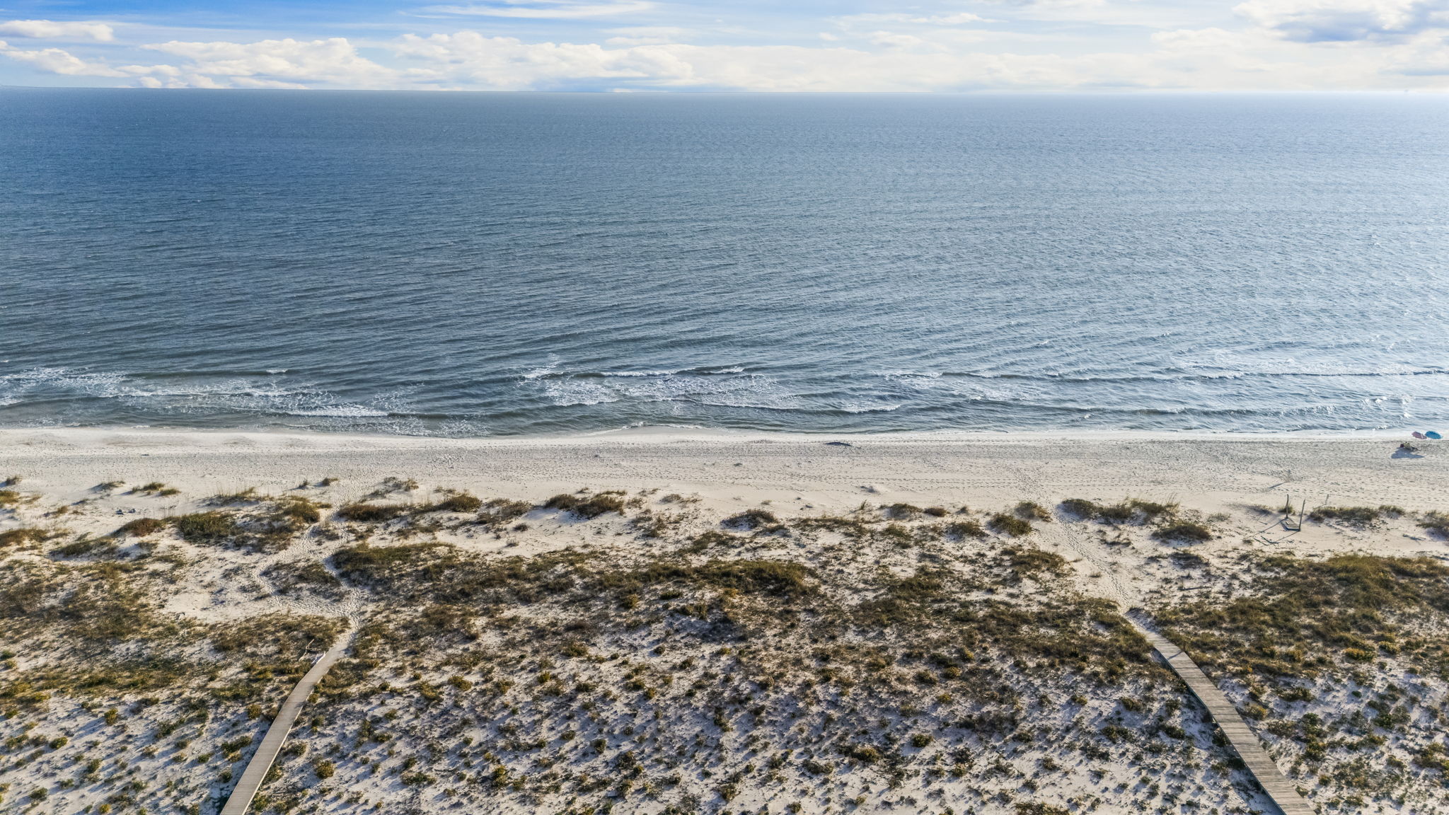 A pristine stretch of sugar-white sand and emerald Gulf waters, framed by natural coastal dunes—this private Kiva Dunes beach access offers a peaceful, uncrowded setting that feels worlds away from the typical crowded shoreline.