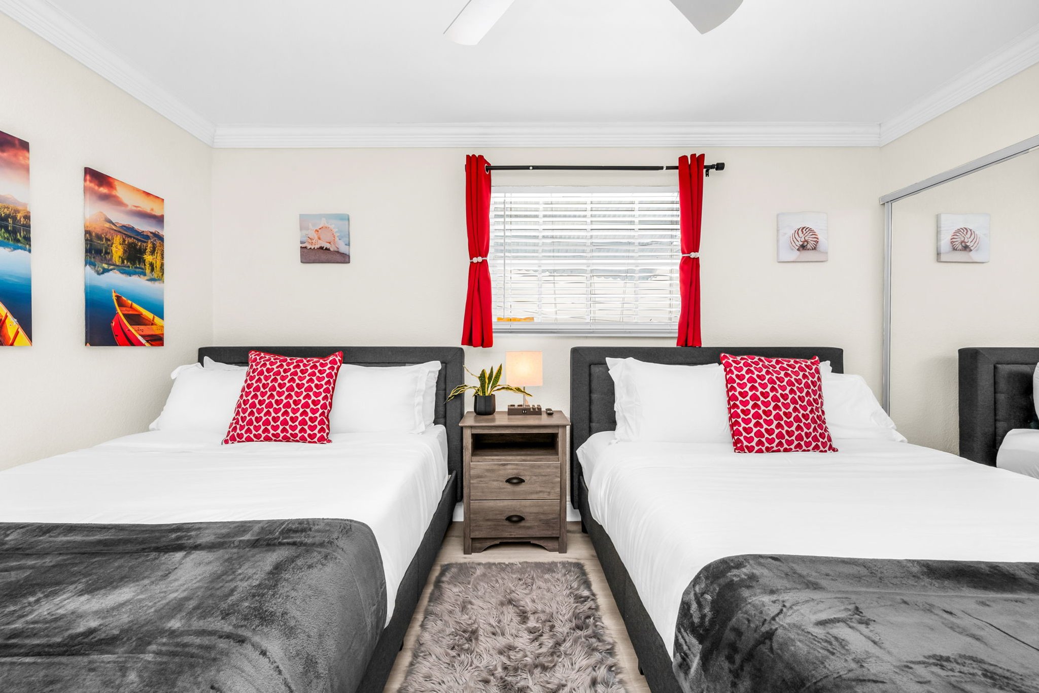 This inviting ensuite bedroom offers two plush queen beds, a smart TV for cozy nights in, and plenty of closet space plus a built-in vanity mirror for getting ready.