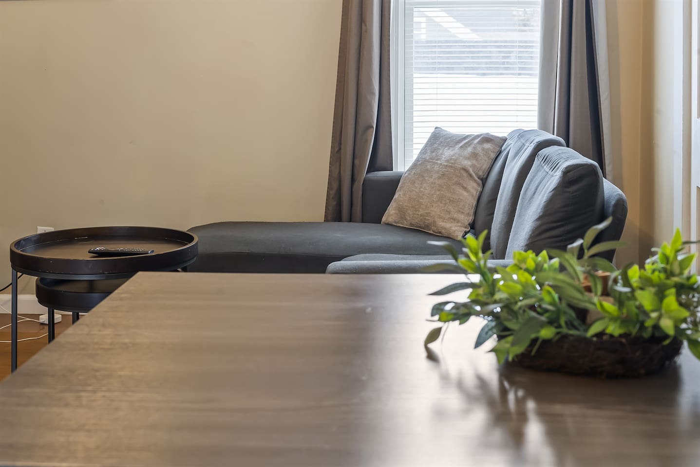 View of the cozy living room couch from the dining area, creating an open and inviting space for relaxation and meals.
