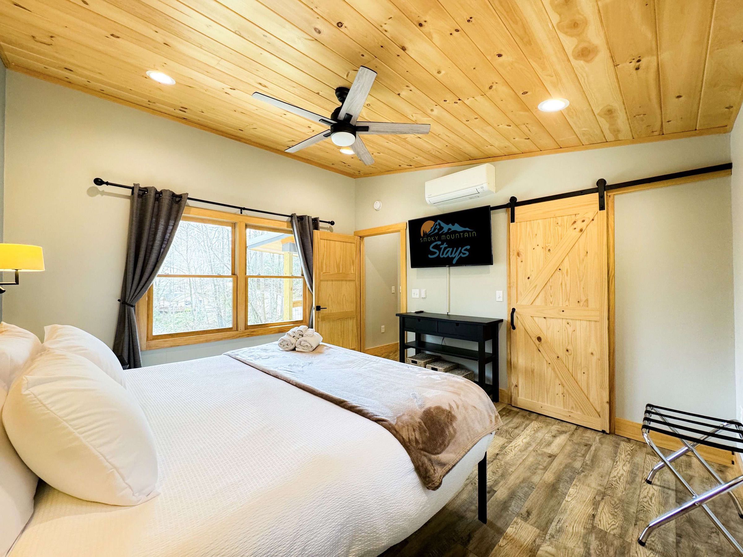the master bedroom is complete with a smart TV and Luxurious King bed and bedding.