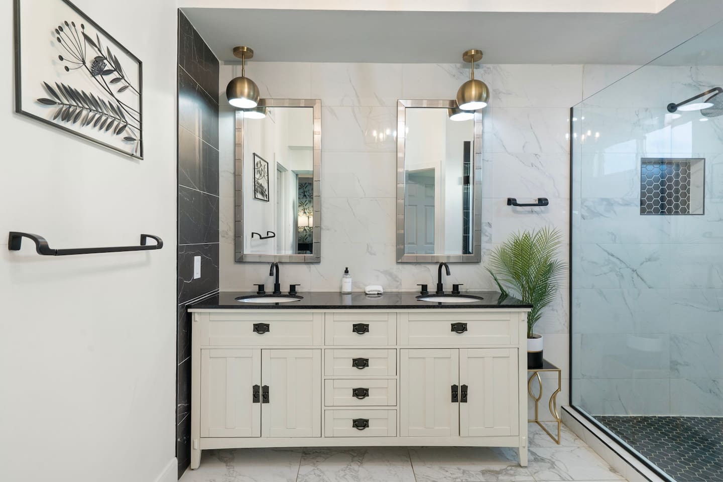 Dual vanities and designer lighting bring a boutique-hotel feel to daily routines.