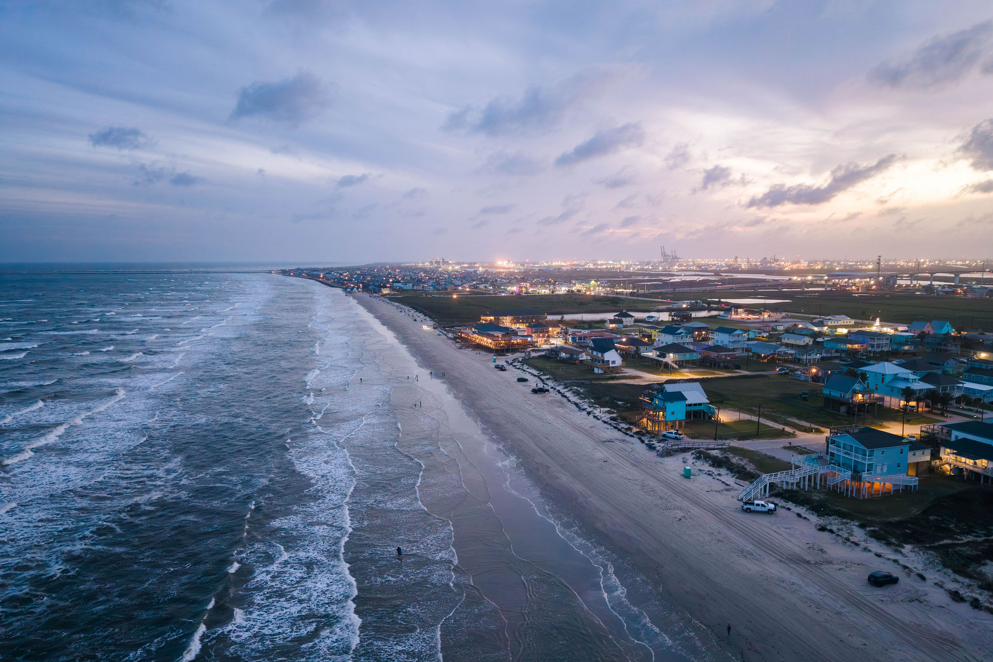 That's the house from above at dusk. Walkable to the Surfside pavilion and beach — quieter once the sun goes down.