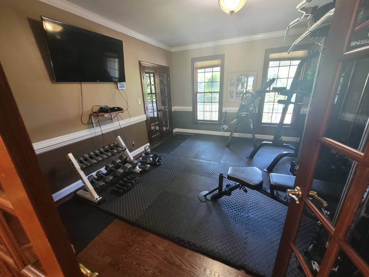 Exercise Room with dumbells, large smart TV to watch when working out, inspire F2 Functional Trainer, dip bar, pull up bar,